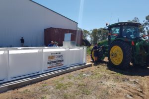 farmer filling up tractor from Farm tank